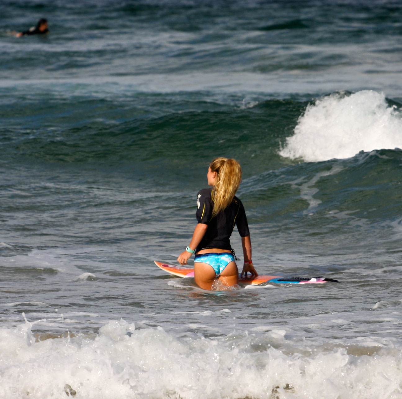 girl with surfboard in ocean